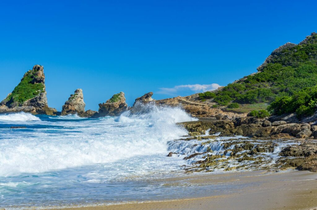 Wellen an den Felsen der Küste bei Pointe des chateaux, Guadeloupe, Karibik